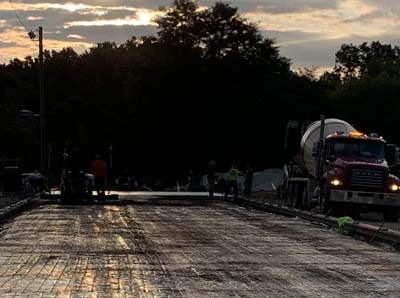 Gold Metal Construction Pouring Concrete At Dusk